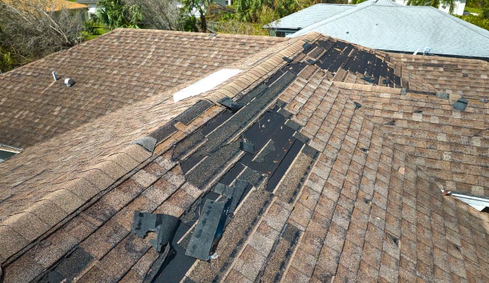 Damaged roof with missing shingles