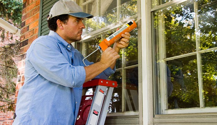 Professional worker repairing window