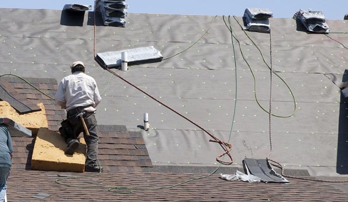 A person replacing a roof